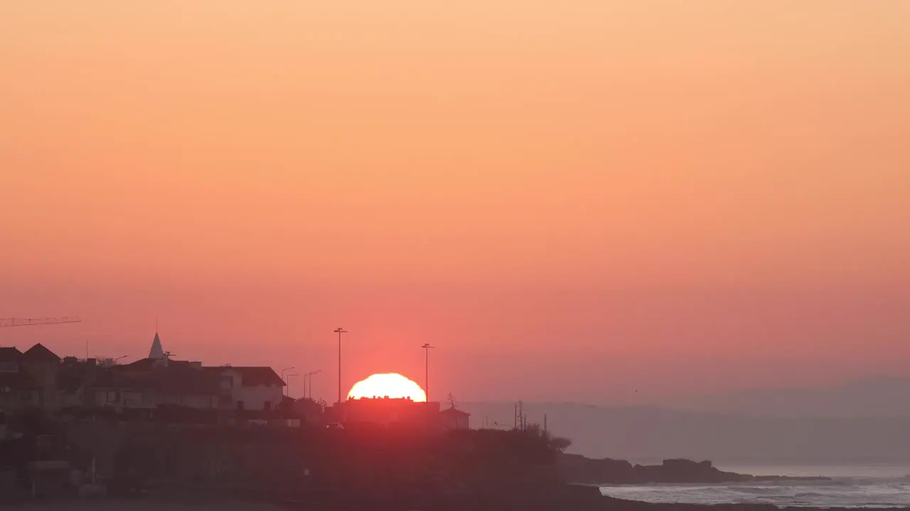 Timelapse of a Beautiful tropical sunrise over the sea and city at Estoril Cascais near Lisbon Portugal