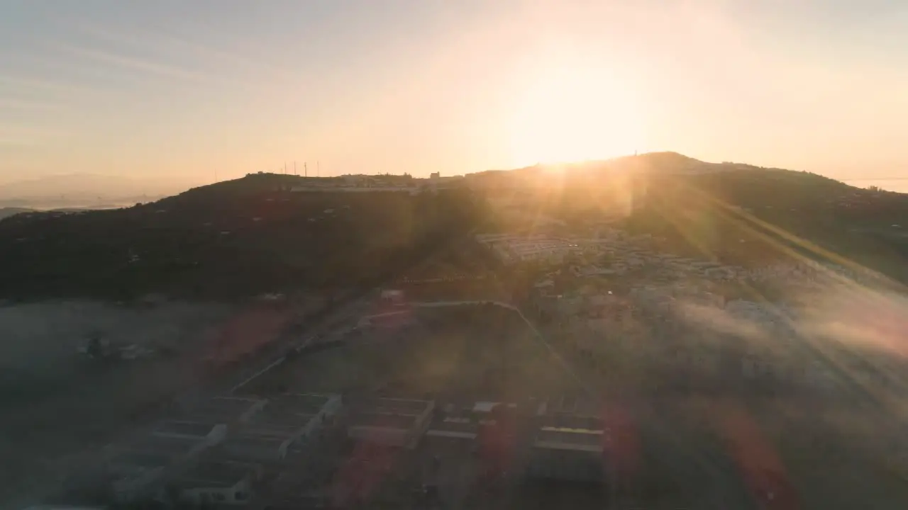 Aerial drone shot in slow motion of a beautiful sunset on a mountain of medina sidonia in andalucia in spain on a cloudless day