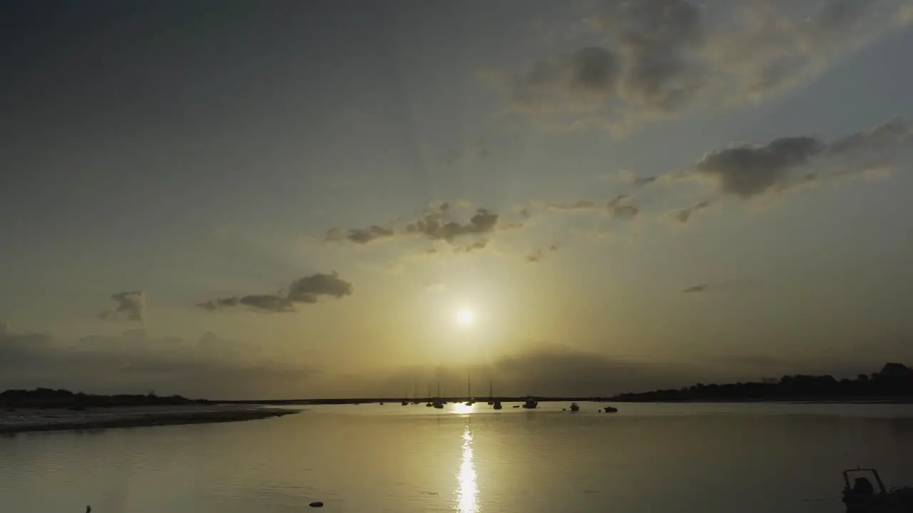 River sunshine in the morning with silhouette boats floating at Tavira Portugal