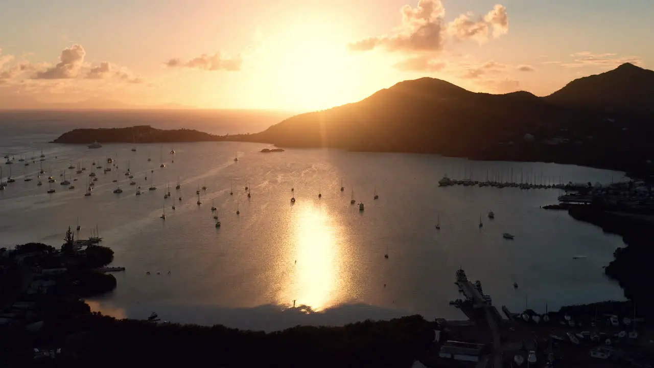 Aerial shot of sunset in English Harbor in Antigua Caribbean with views of yachts sailboats marina bay and cliffs