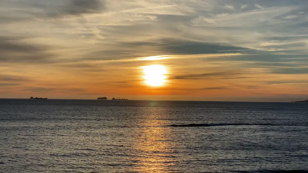 4k Big Sunset Over Ocean with some boats sailing