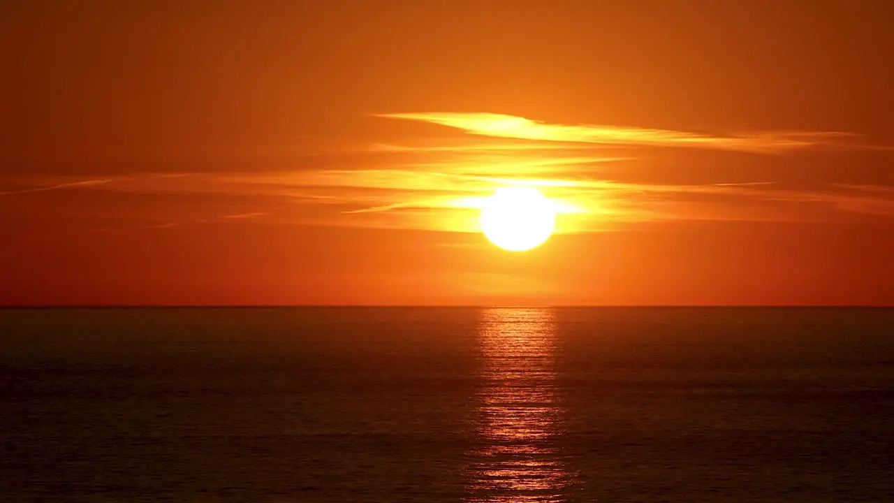 dramatic Sunset Timelapse on a beach among some clouds in Cascais