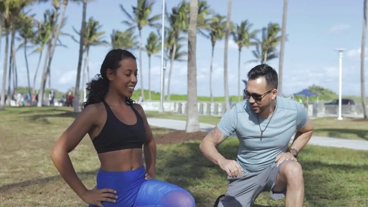 Girl training with personal trainer in park