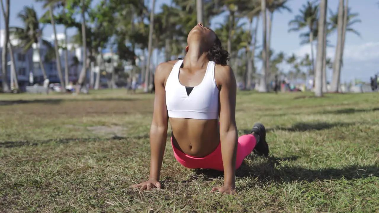 Concentrated black woman working out on lawn