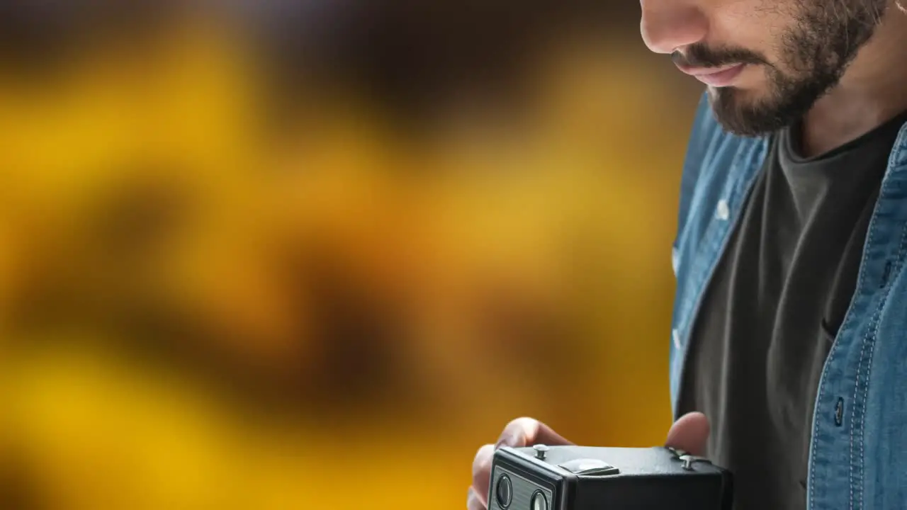 Animation of caucasian man taking photo with camera over orange background