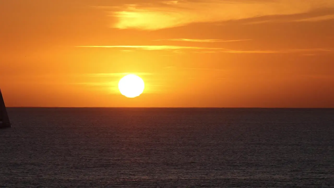 timelapse of sunset reflecting and flashes on the sea