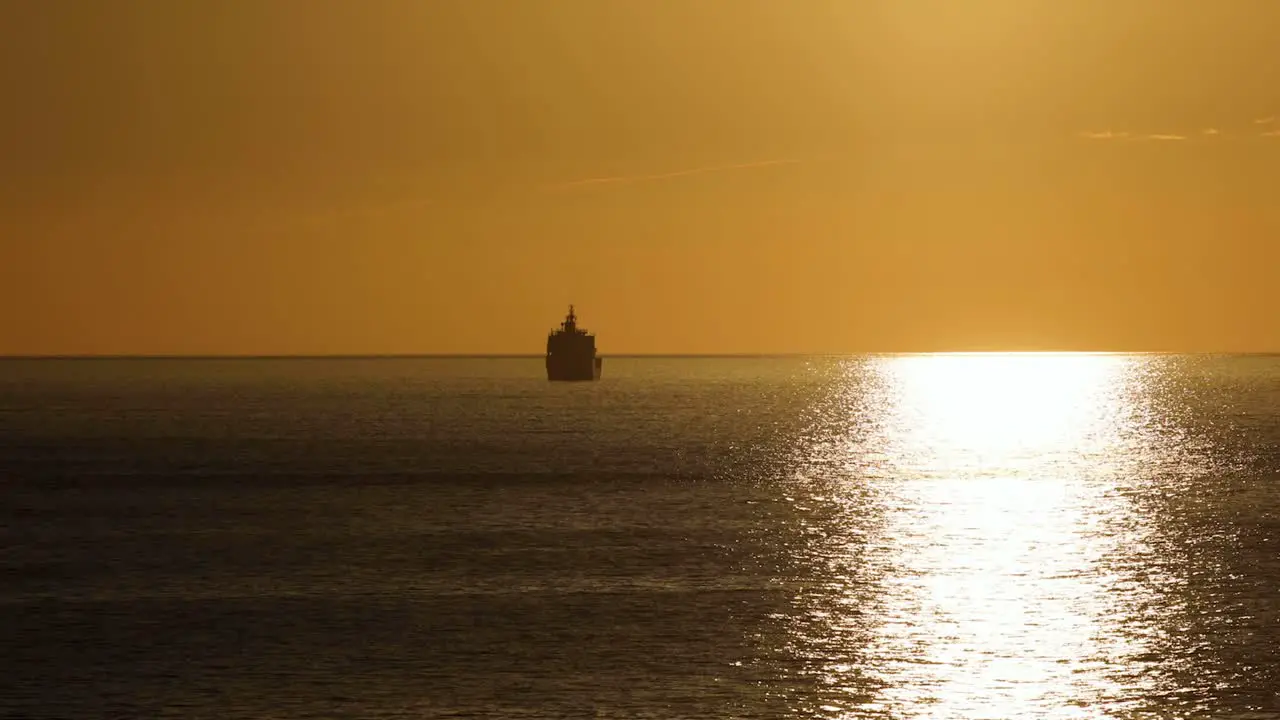 Ocean orange sunset landscape cargo ships sail in evening light