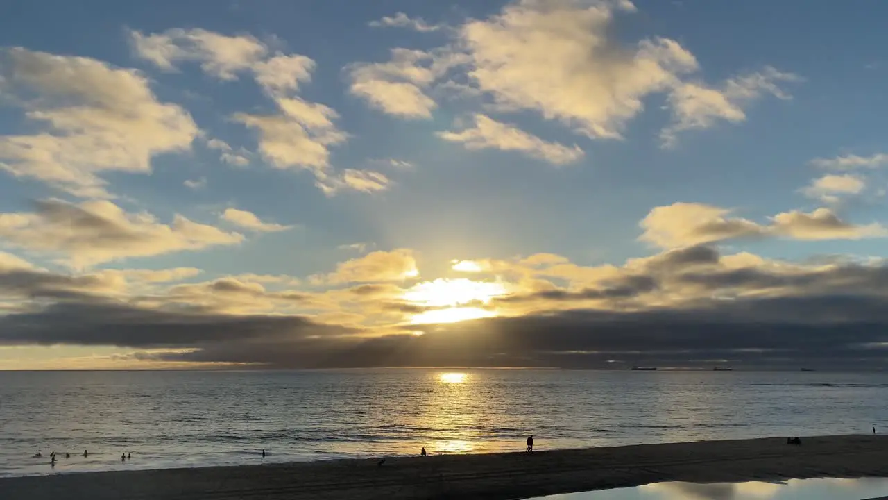 close up of sun rays and clouds and huge reflexion on water of ocean