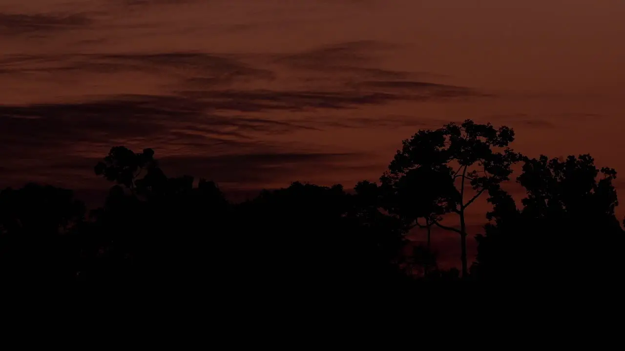 Sunset revealing this fantastic warm colors reflected on the sky and clouds moving to the right until dark Khao Yai National Park Thailand