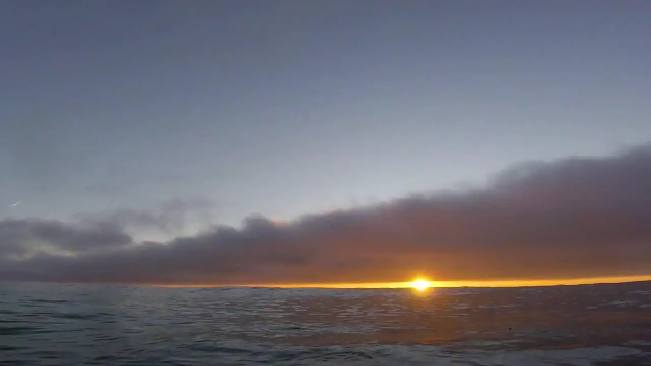 Surfer showing an amazing sunset with go pro