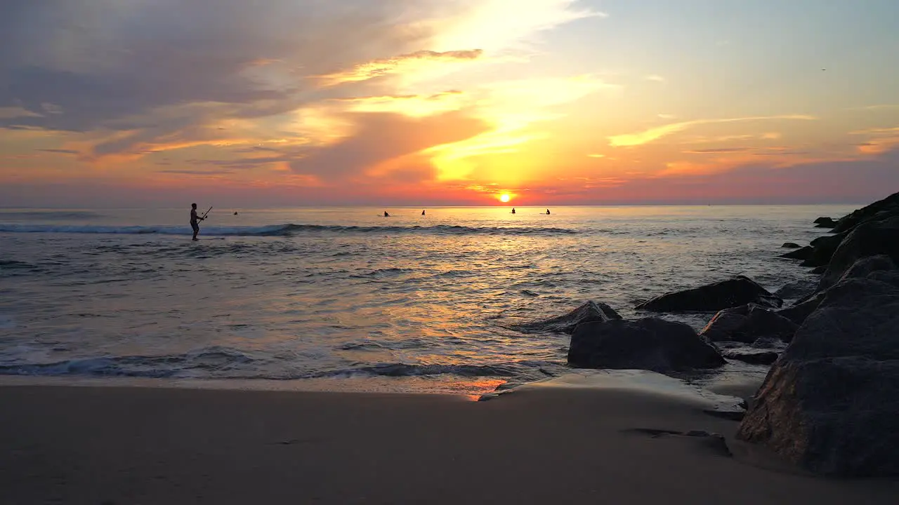 Early Morning Exercise at the Beach Silhouette Paddle Boarding from the Beach at Sunrise