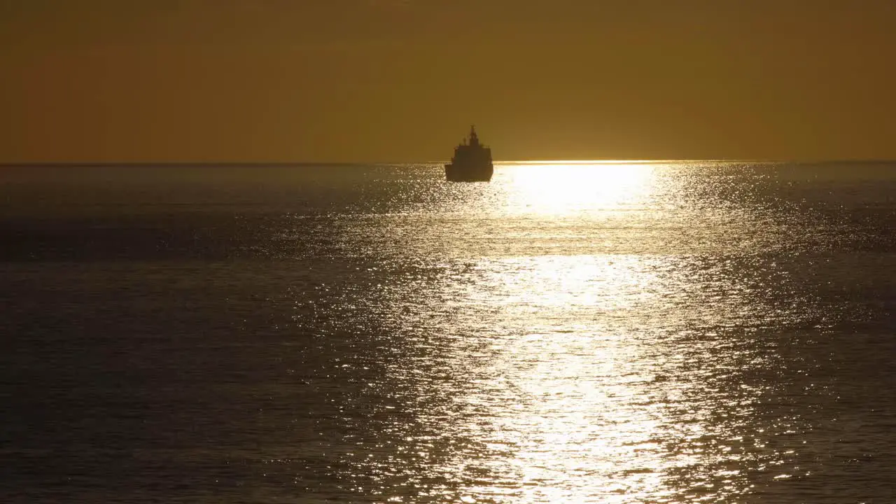 Silhouette Of A Cruise Ship over ocean during Sunset