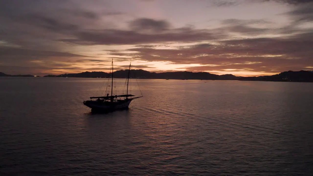 Silhouette of fishing boat drone flyby