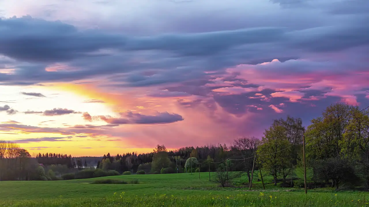 Timelapse of colourful clouds moving over rural landscape