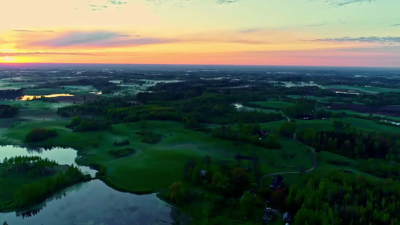 Scenic Sunset on Natural landscape grassland slopes with surrounded by water Aerial tracking shot