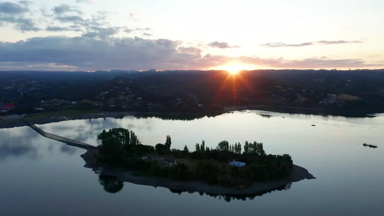 Aerial View Silhouette Of Aucar Island Connected To Island Of Chiloe With Golden Orange Sunset On Horizon