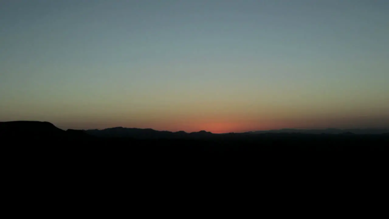 The sun appears over the horizon at golden hour