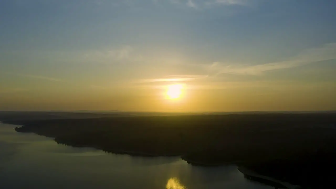 Wide and beautiful view of sun over dam on a huge sunrise in Alentejo Portugal