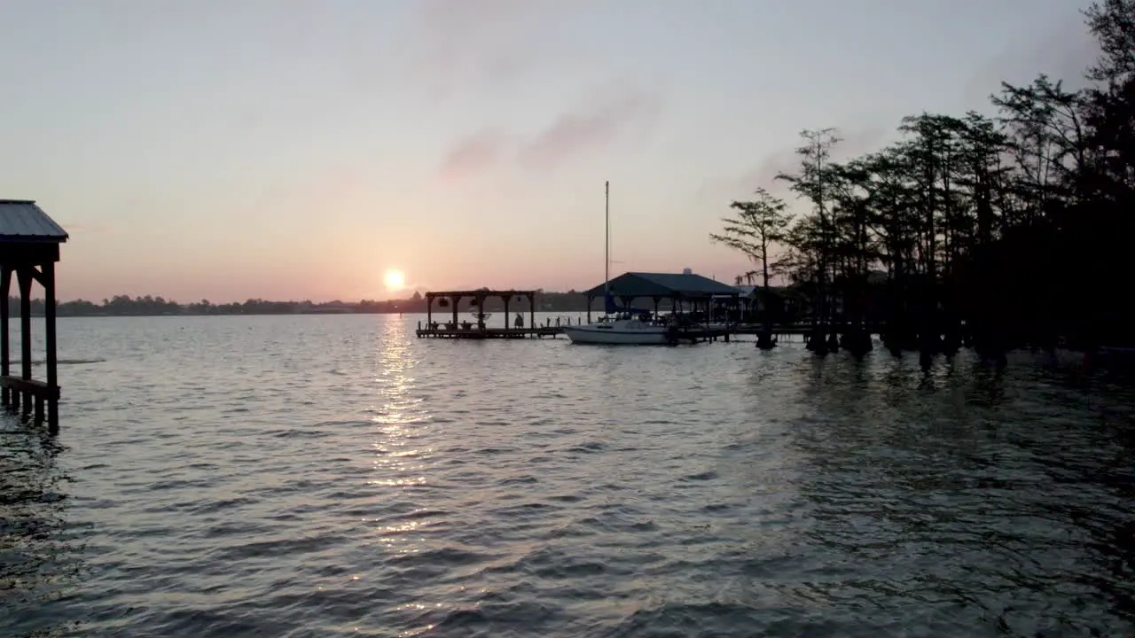 Peaceful sunrise over lake with docks drone shot