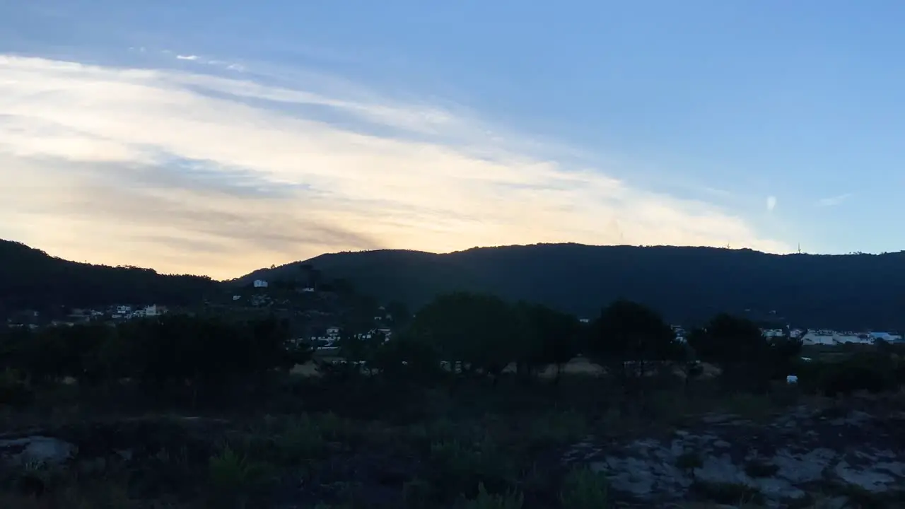 amazing sunrise with mountains and blue sky illuminated clouds