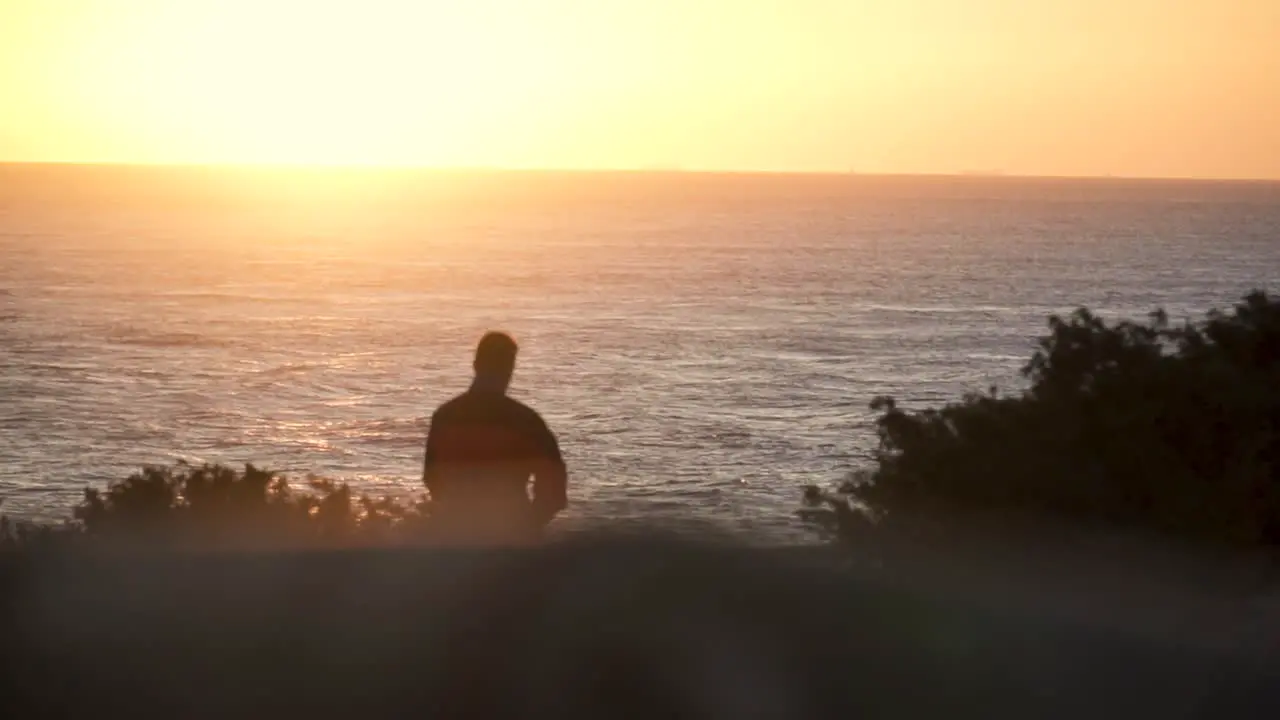 Slow Motion Shot Of Man Walking Towards Sea At Sunset Cadiz Spain