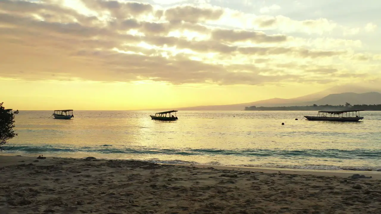 A beautiful afternoon with the golden sun setting and glistening in the shallow waves of a tropical beach island