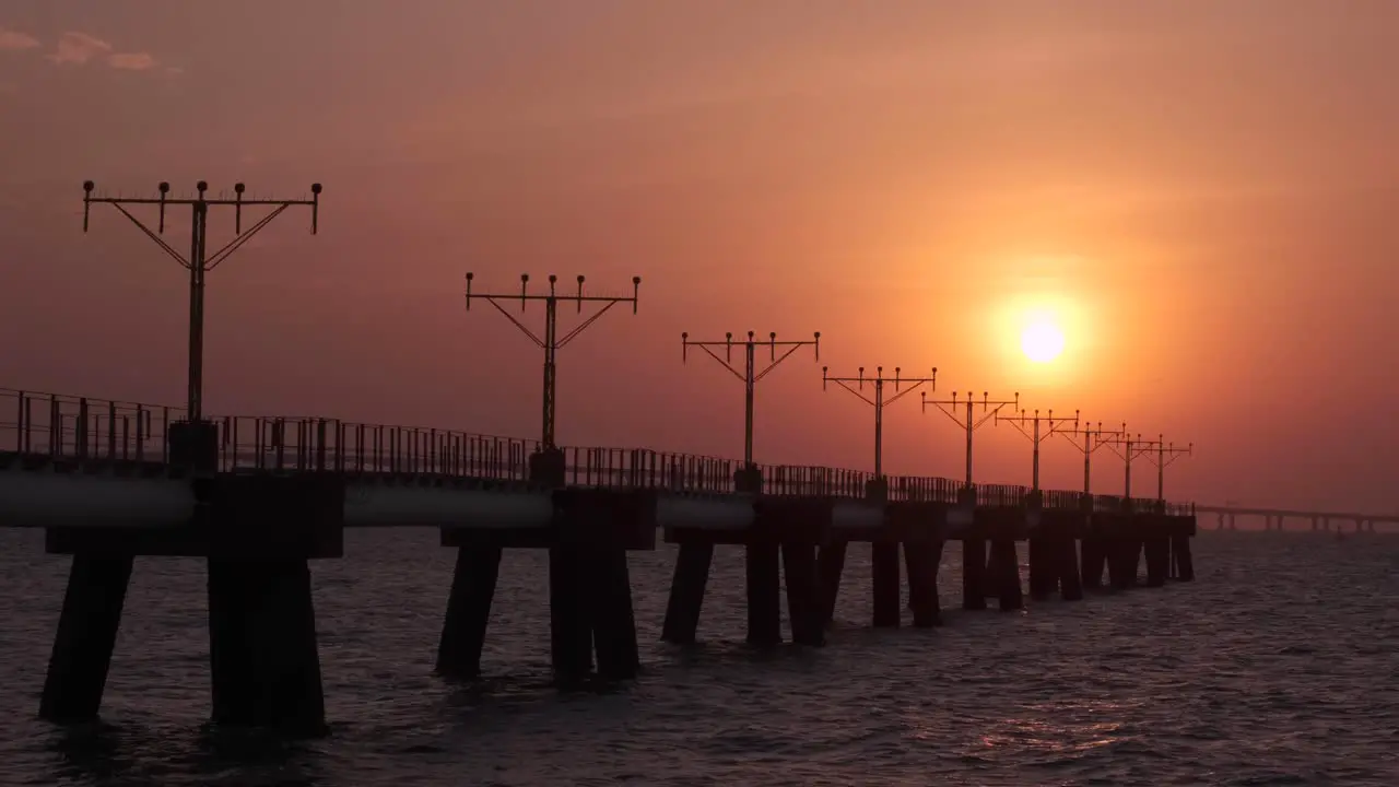 Pan shot of the approach lighting system towers at sunset