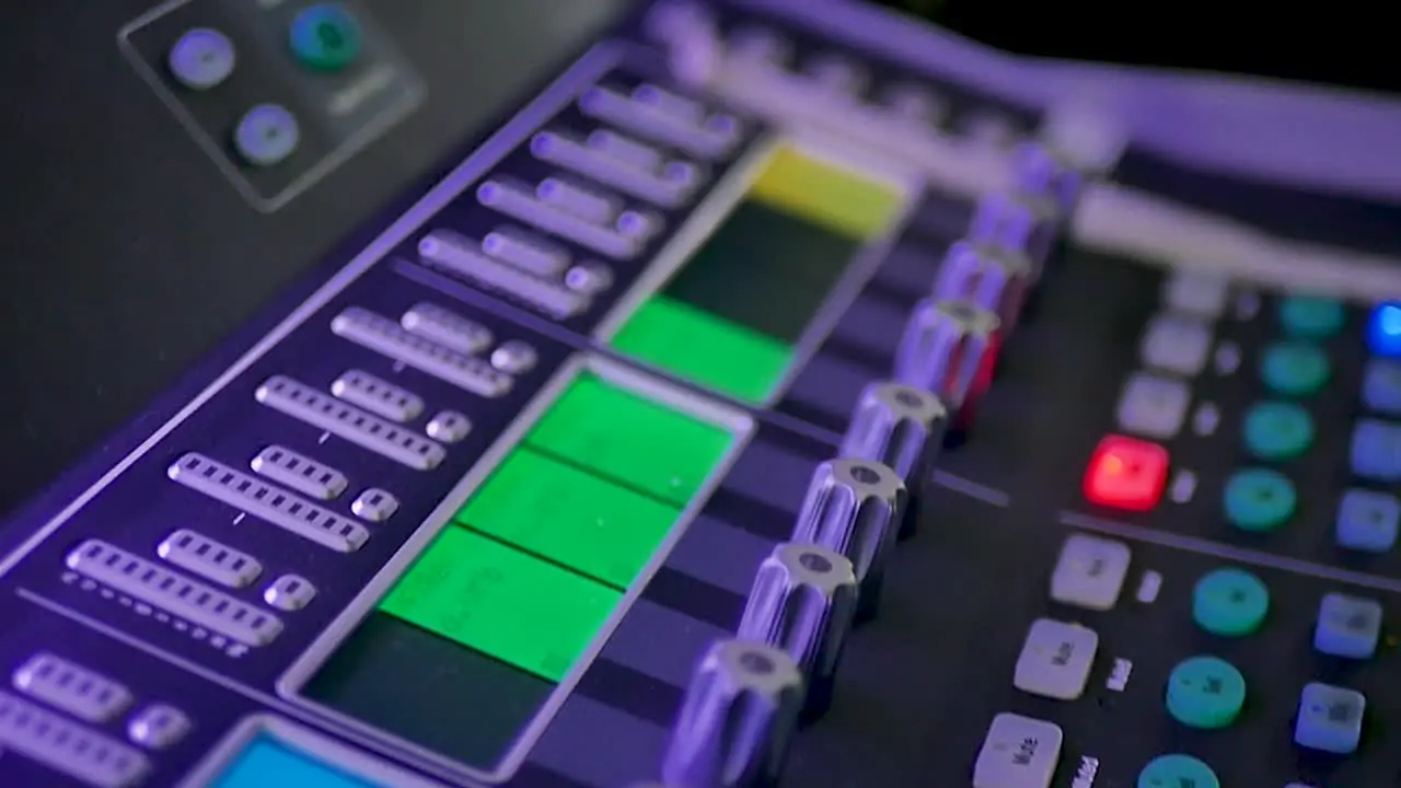 A detailed close-up shot of an audio mixer showcasing the intricate knobs sliders and buttons