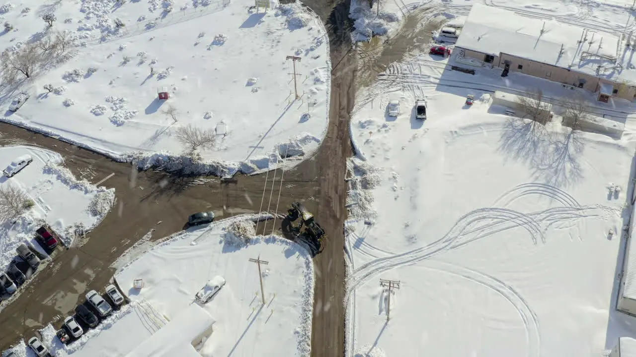 Aerial Directly Above Tractor on Working Farm in Snowy Conditions in California United States