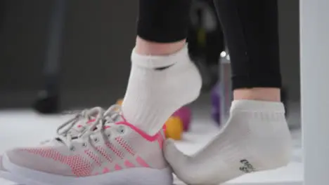 Vertical Shot of Girl Putting on Gym Shoes 