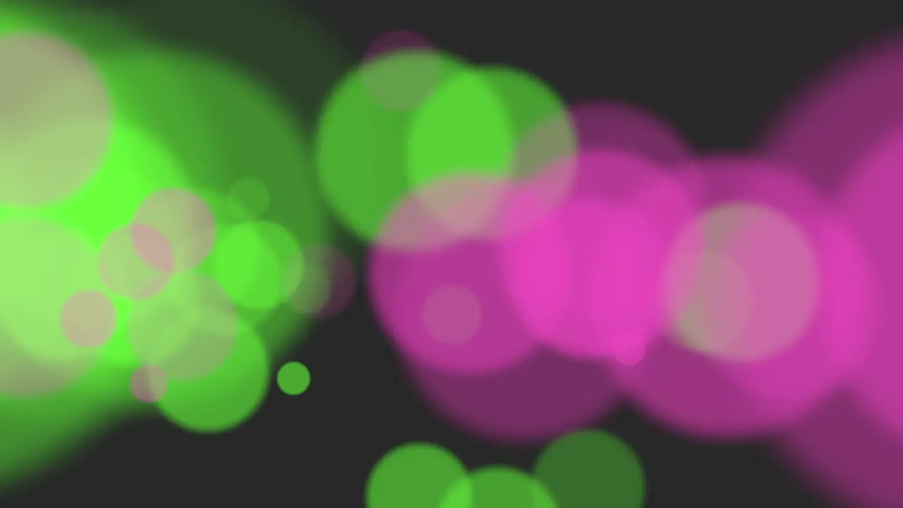 Dynamic abstract circles blurred pink and green circles in motion on black background