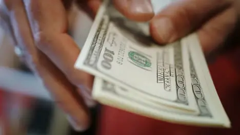 Human hands counting dollar bills Close up of hands count money cash