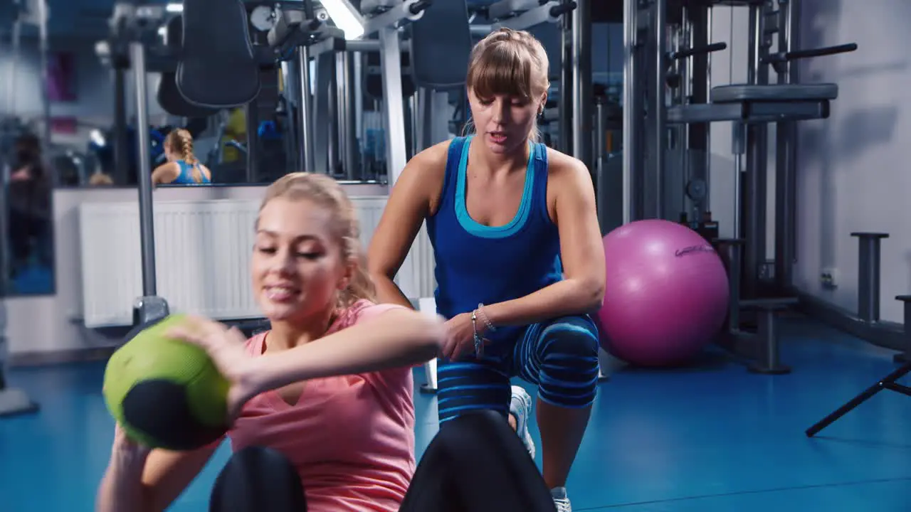 Young women do fitness training on a ball