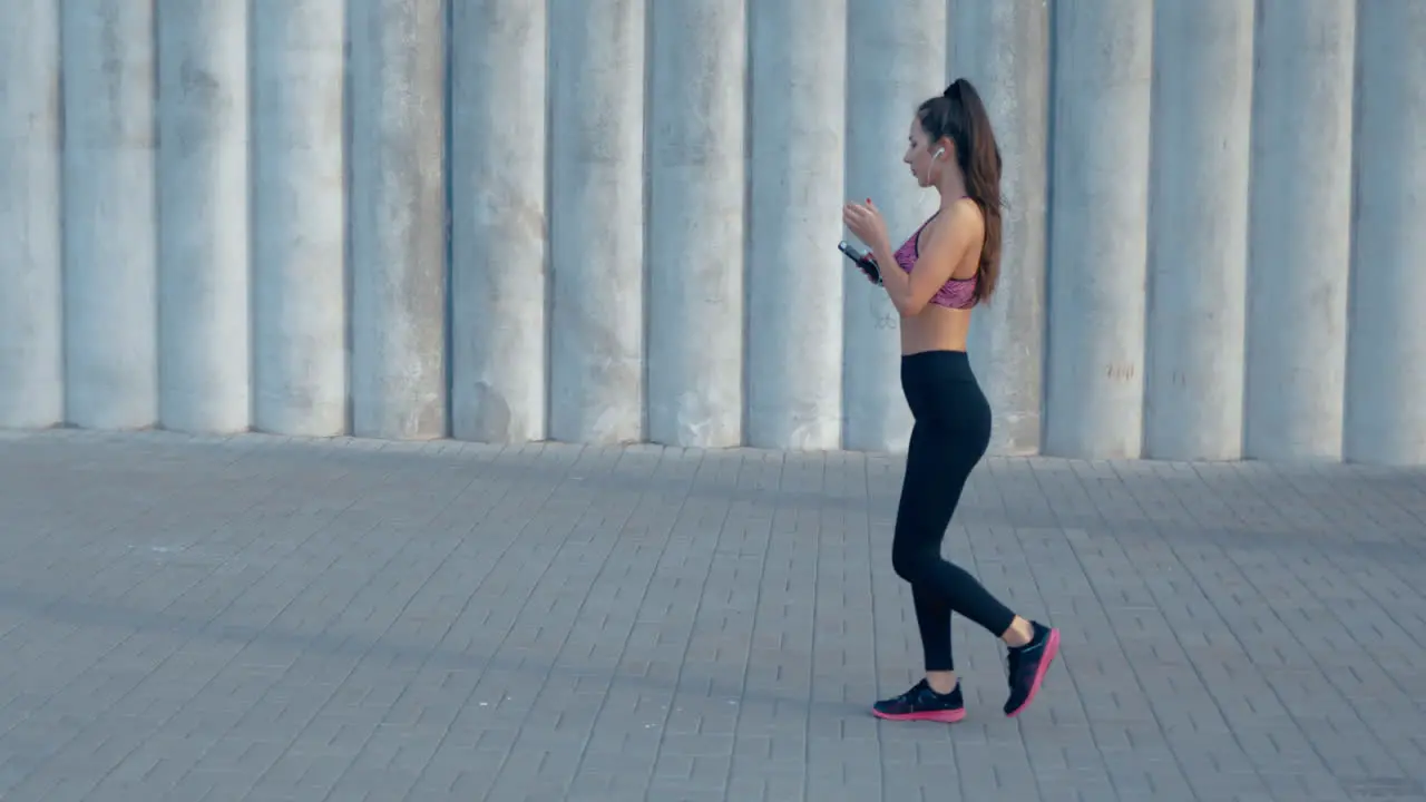 Woman Choosing Music Before Run