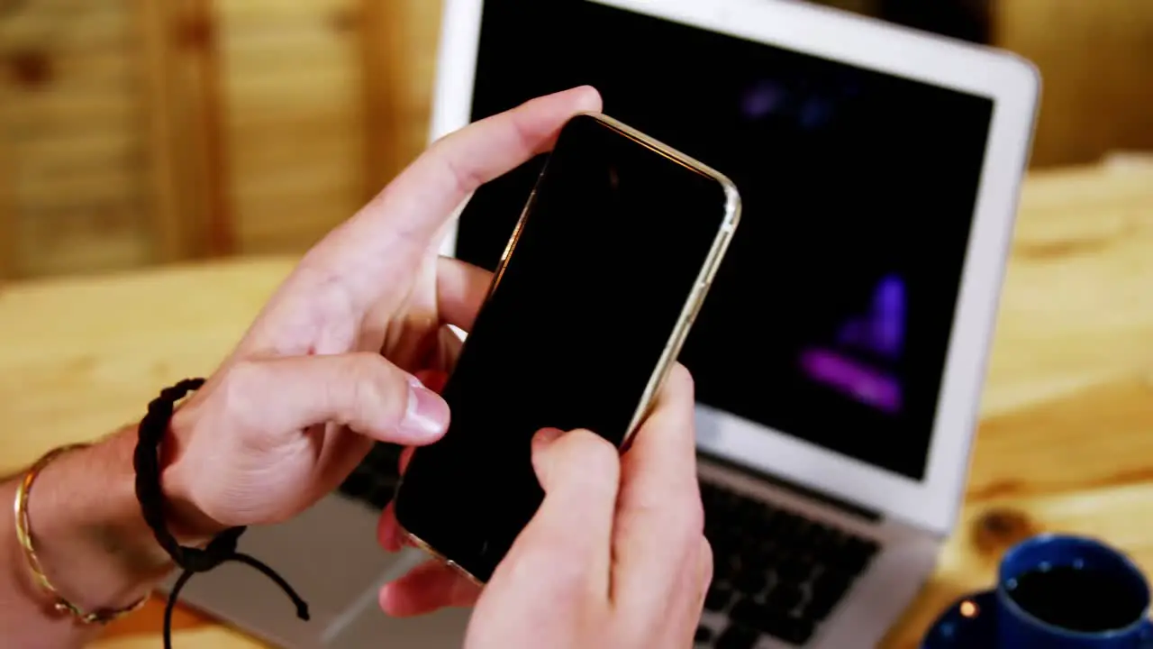 Male customer using mobile phone at counter