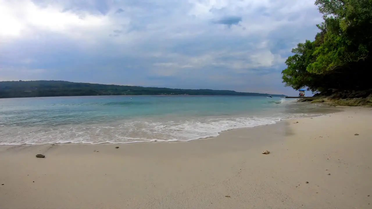 time lapse of white sandy beach and blue waters