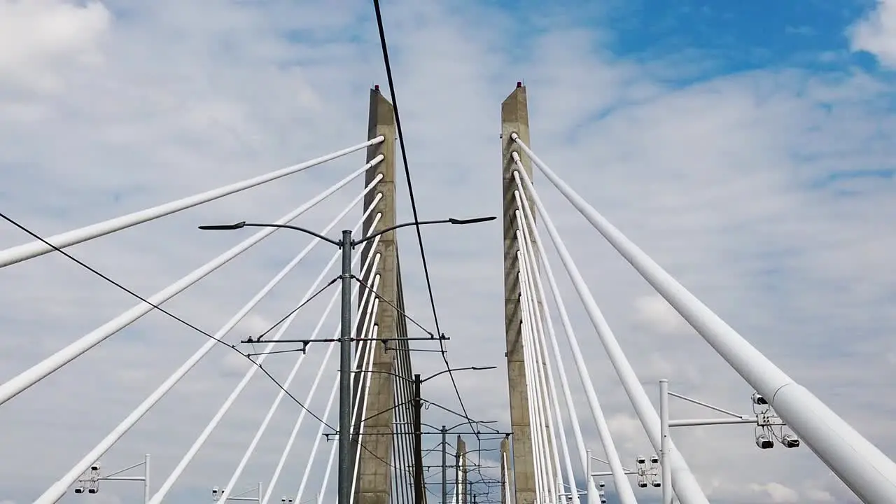 HD Looking up going across Tilikum Crossing Bridge in Portland Oregon with mostly cloudy sky take one