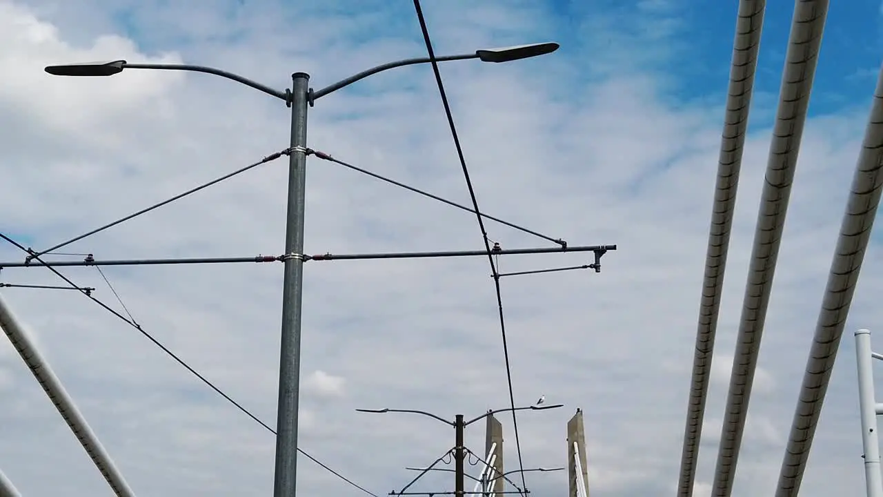 HD Looking up going across Tilikum Crossing Bridge in Portland Oregon with mostly cloudy sky take five