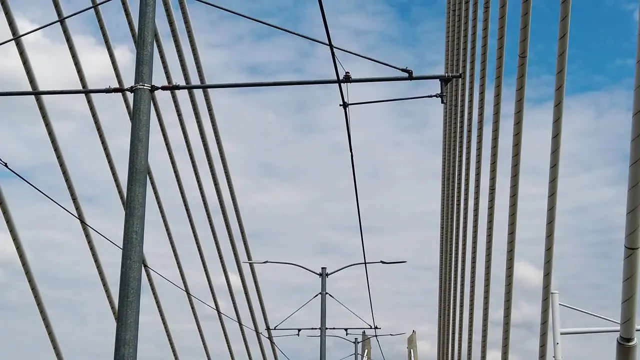 HD Looking up going across Tilikum Crossing Bridge in Portland Oregon with mostly cloudy sky take four