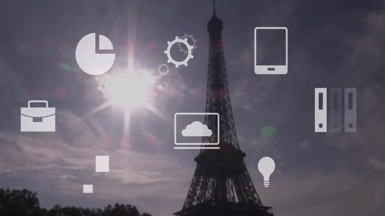 Animation of multiple icons over eiffel tower against sun and cloudy sky