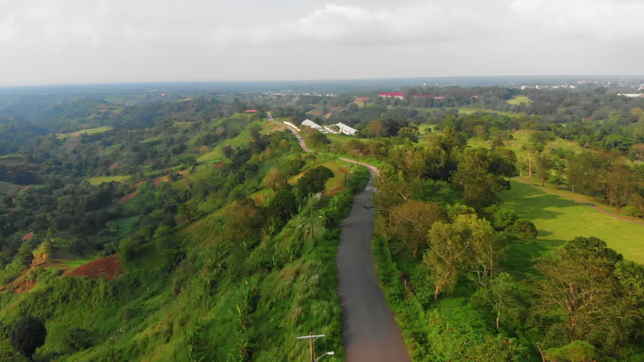 Reverse aerial reveal of mountain road and stunning Nasugbu landscape