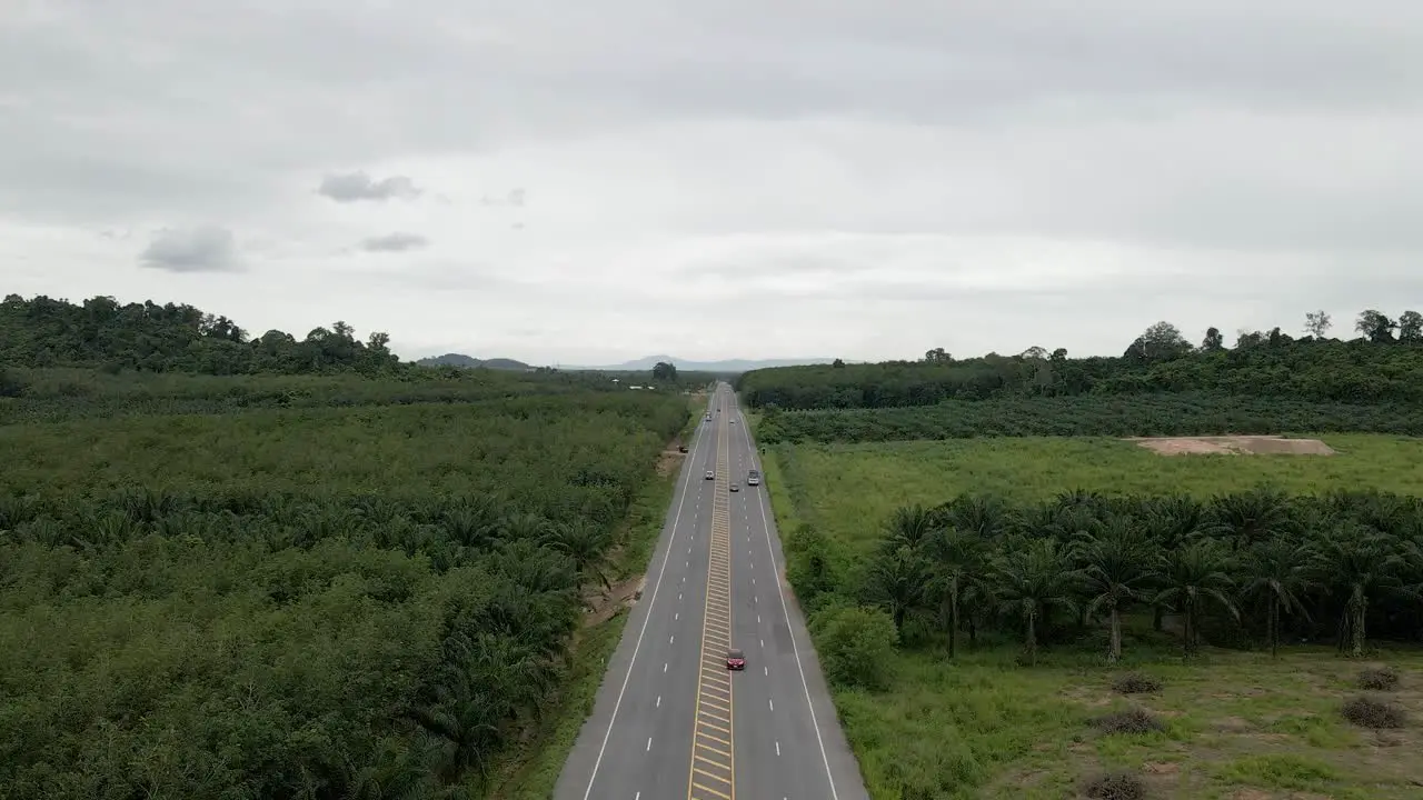 Aerial view of highway in countryside on cloudy day forward movement