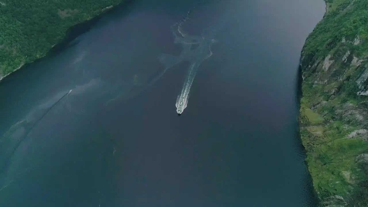 Aerial Slomo Top shot of a Boat in the Middle of the Geirangerfjord Norway