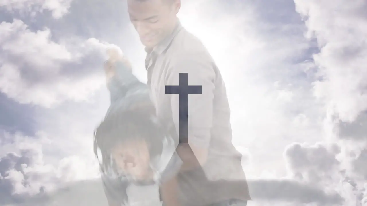 Animation of crucifix cross monument and cloudy sky over biracial father playing with son