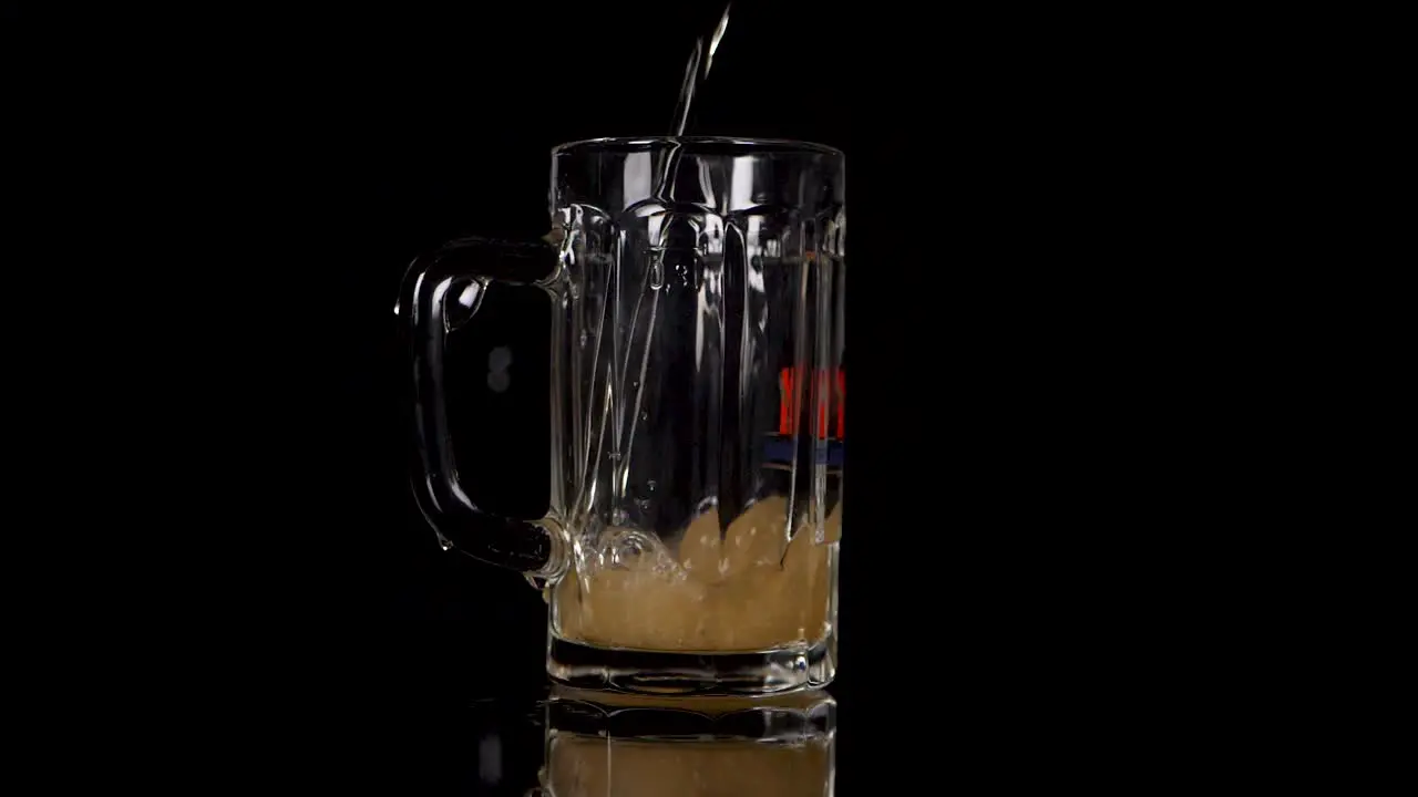 Slow motion pouring beer in a glas some drops are going wrong