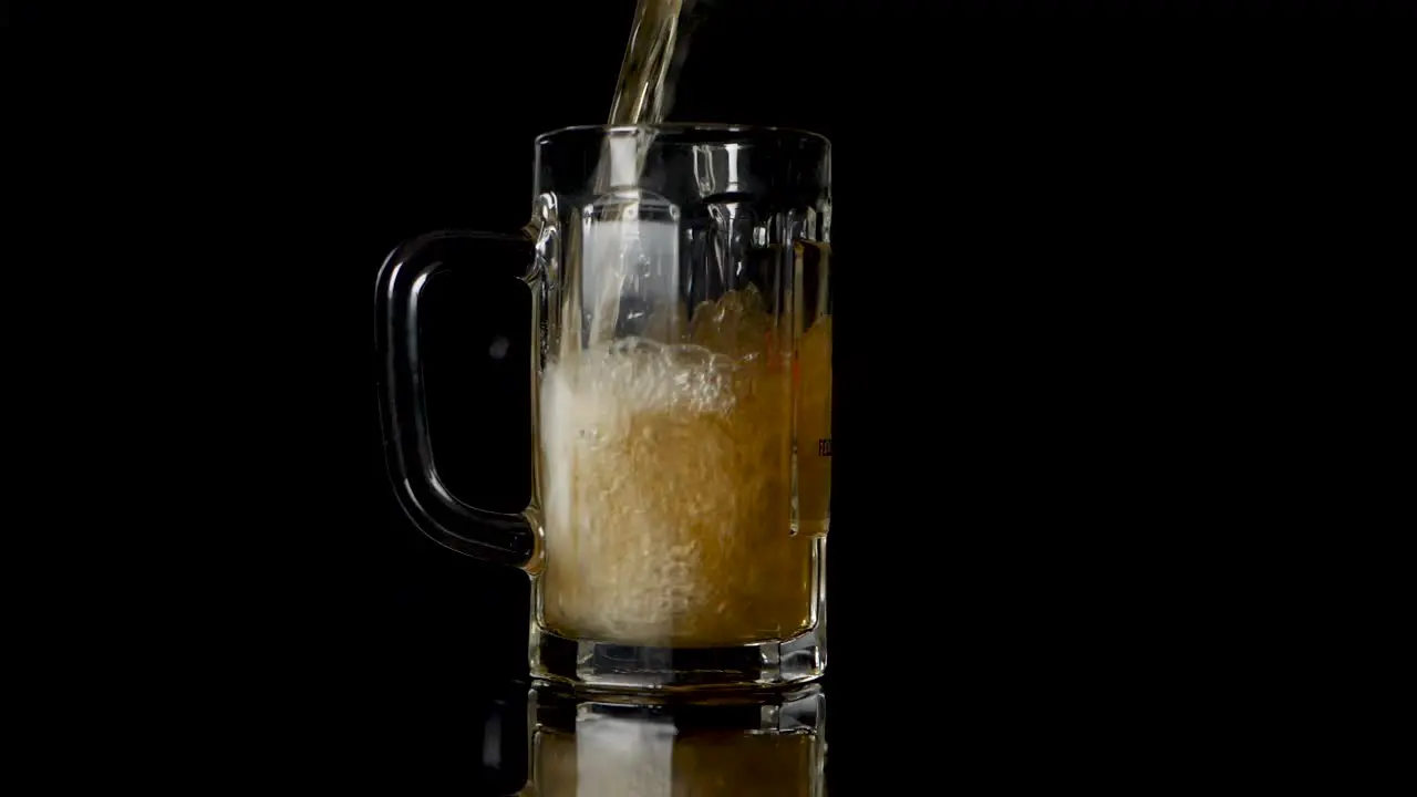 Pouring beer in a mug but some drops are going wrong