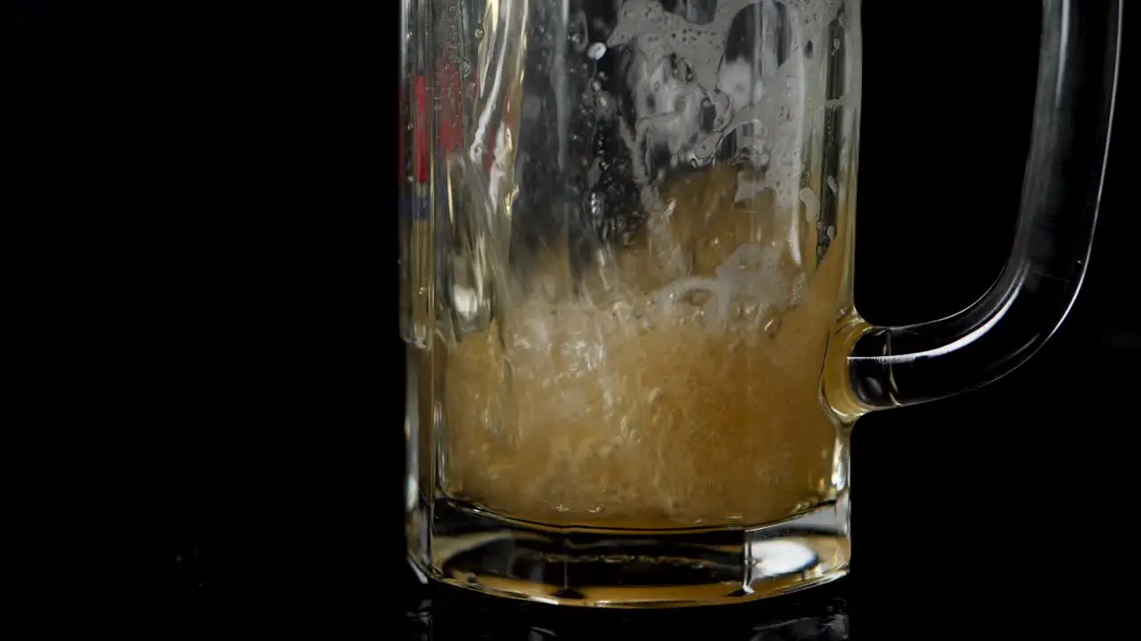 Pouring beer in a mug in slow motion