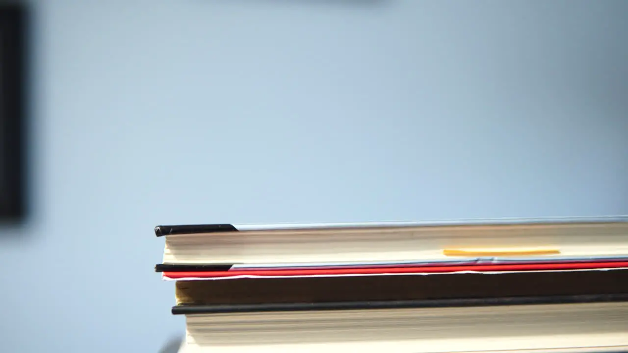 close up book on stack inside room on table tilt camera