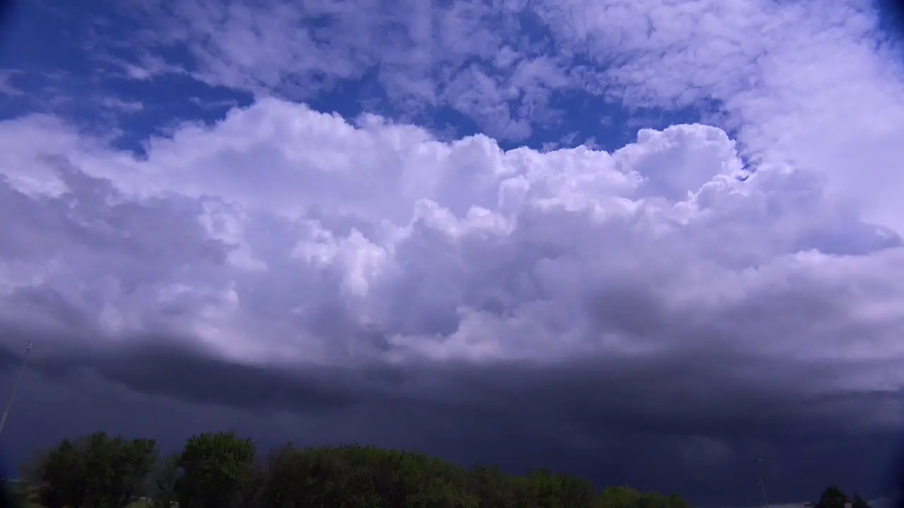 Large white thunderclouds loom on the horizon as a storm moves in