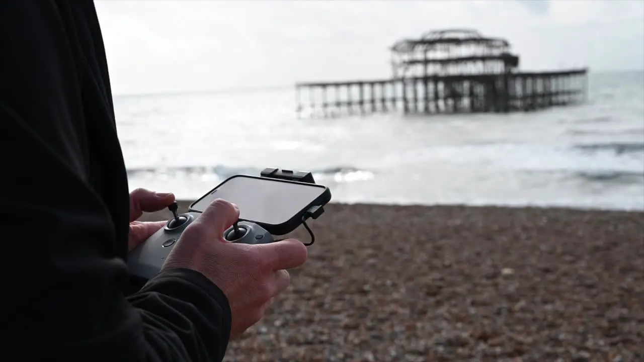 remote control with phone to fly a drone Brighton Beach Sussex